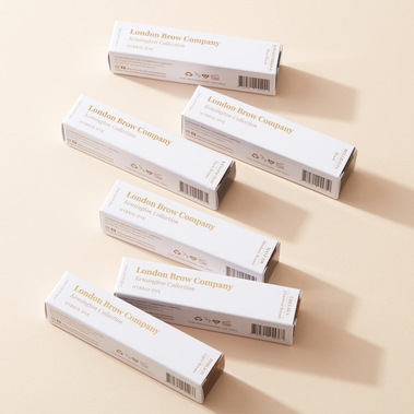 Make up product photography for white packaging on a beige background