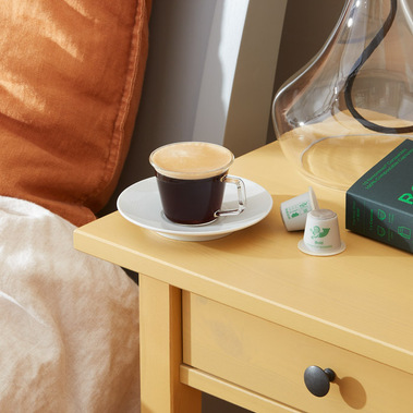 Coffee product photography.  Espresso coffee on a yellow bedside table 