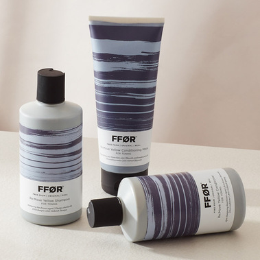 Haircare product photography, three bottles in hard shadows on a neutral background
