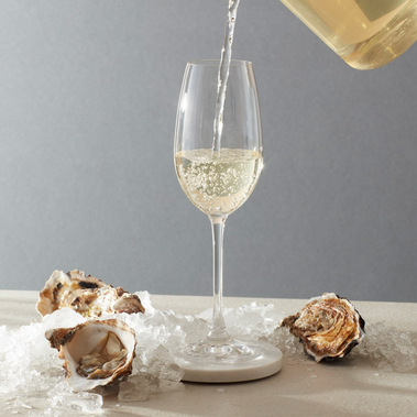 Yellow Tea Buds premium cold brew tea being served in a champagne glass with oysters and ice