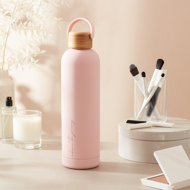 Water bottle on a dressing table in dappled sunlight