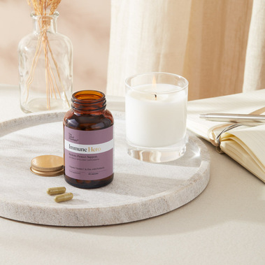 Supplement bottle on a bedside table with journal