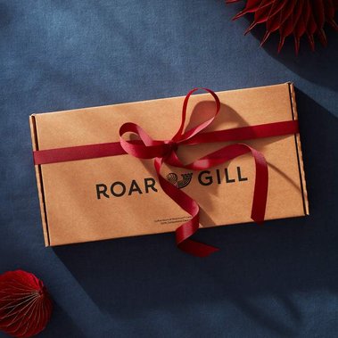 Christmas product photography for coffee capsules box unwrapping red ribbon