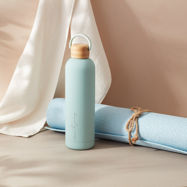 Blue water bottle with a yoga matt and towel