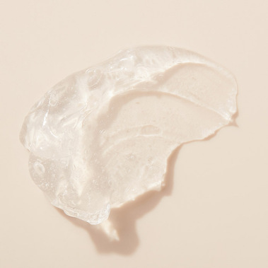 Moisturiser texture smear swatch on a warm background