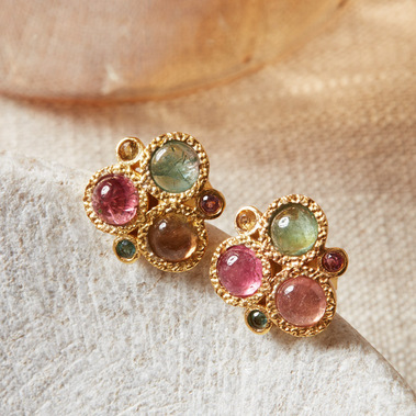 Multi-coloured tourmaline stud earrings on a grey stone jewellery box