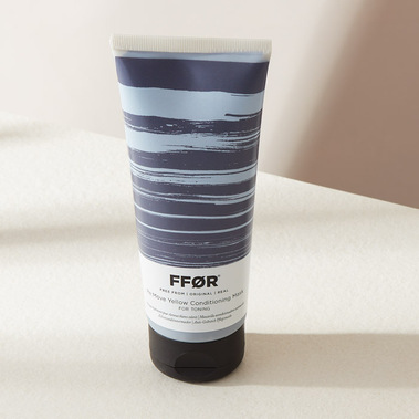 Haircare product photography, hair mask bottle in hard shadows on a neutral background