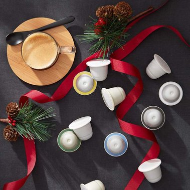 Christmas product photography for coffee capsules with red ribbon and a charcole grey background
