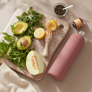 Food photography, chopped ingredients for a smoothie with a water bottle  on a kitchen counter