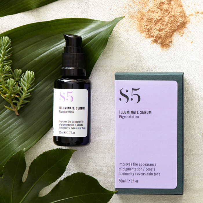 Natural beauty product photography with skincare ingredients and leaves