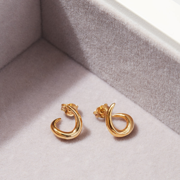 Jewellery Photographer Sally Williams photographs a pair of modern gold earrings in a jewellery box