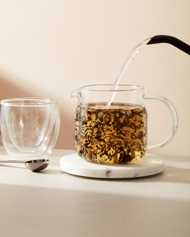 Drinks photography, a pot of loose leaf tea being poured