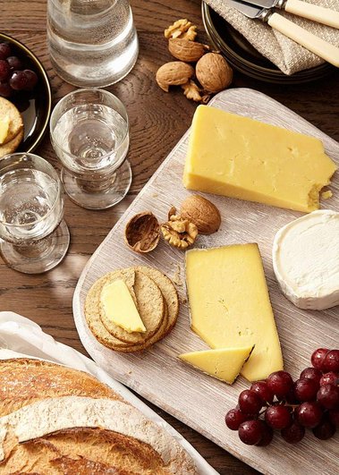 Christmas product photography of a cheese board with sparkling water.