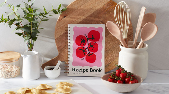 Stationery photography, a recipe journal on a kitchen worktop.  Grey walls and white marble countertop