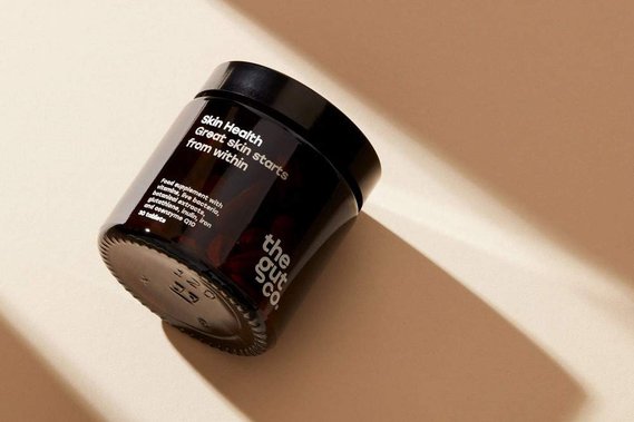 Supplements jar in dramatic shadows on a neutral background