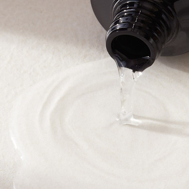 Beauty product photography swatch of haircare liquid spilling out