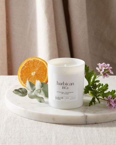 Product photography of a scented candle with ingredients of orange geranium and eucalyptus