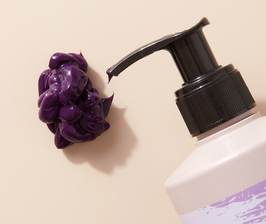 Haircare product photography of a coloured hair mask nozzle and swatch  
