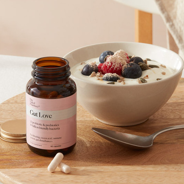 Food supplement capsules with a healthy breakfast of yoghurt and fruit 