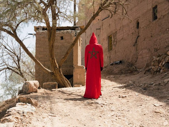 red flag serie shot in merzouga. man wearing a costume un sunset. wearing Five star maroc flag and face miror. art photography. Concept photography speaking about identity. draa valley marocco
Serie red flag photo prise à merzouga au maroc.