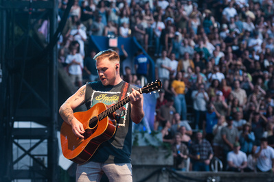 Zach Bryan performing at Forest Hills Stadium