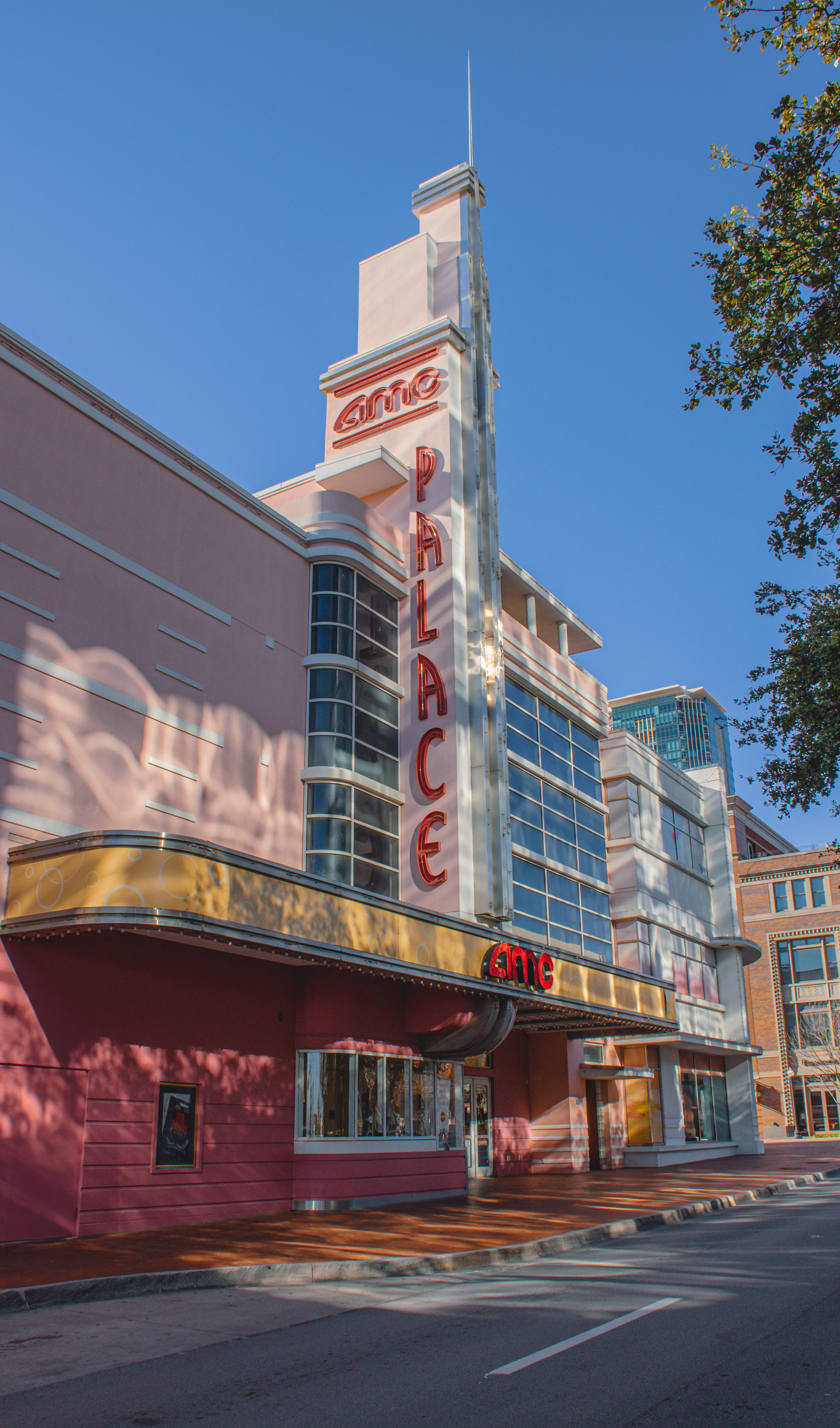 The art deco exterior of AMC’s Palace Theater blushes in pinks and pastels, recalling the glamour of yesteryear’s silver screens and Friday night crowds.