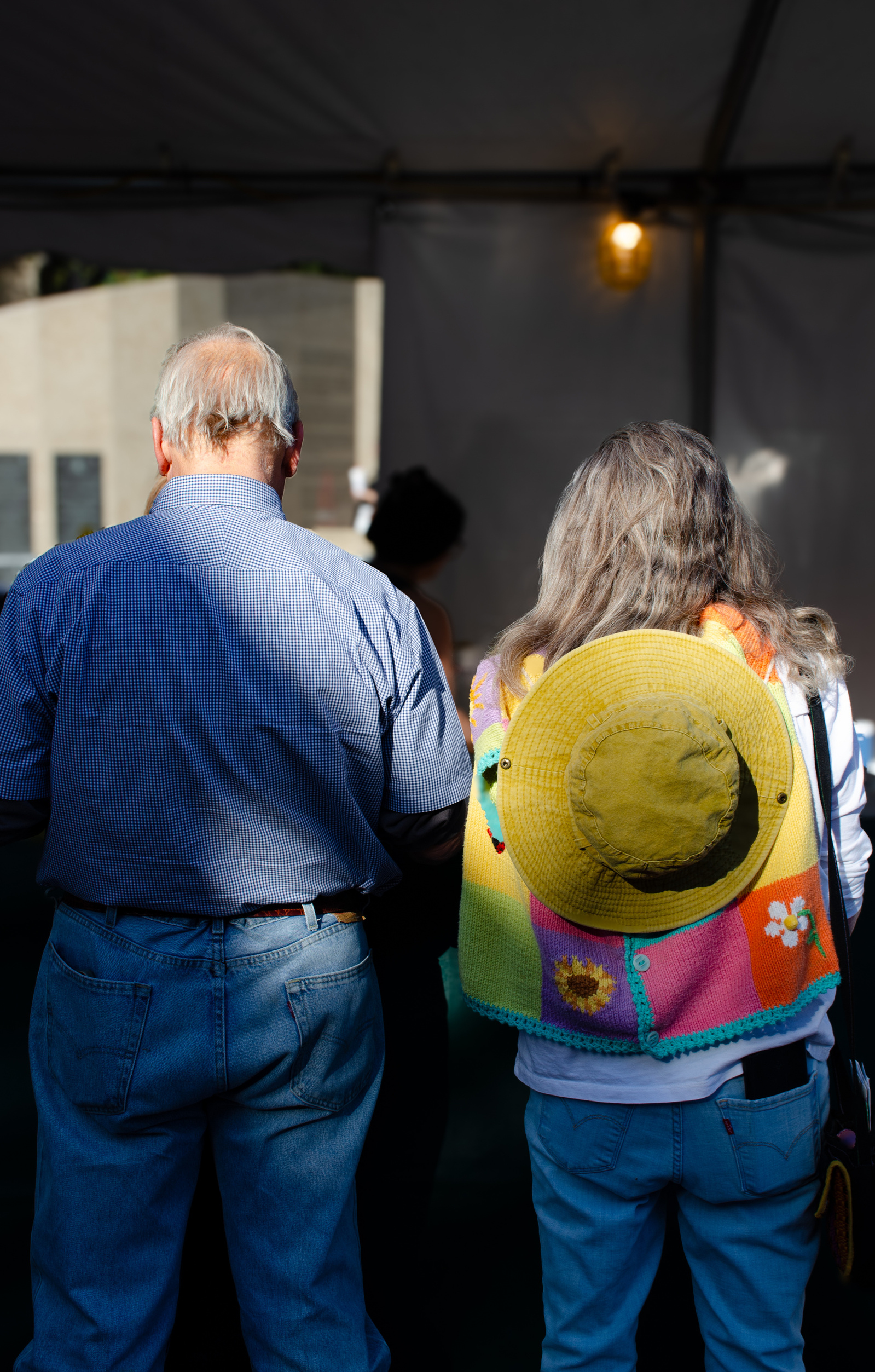 Side by side under the fair tent light—stitching together a moment of color and age and quiet understanding.