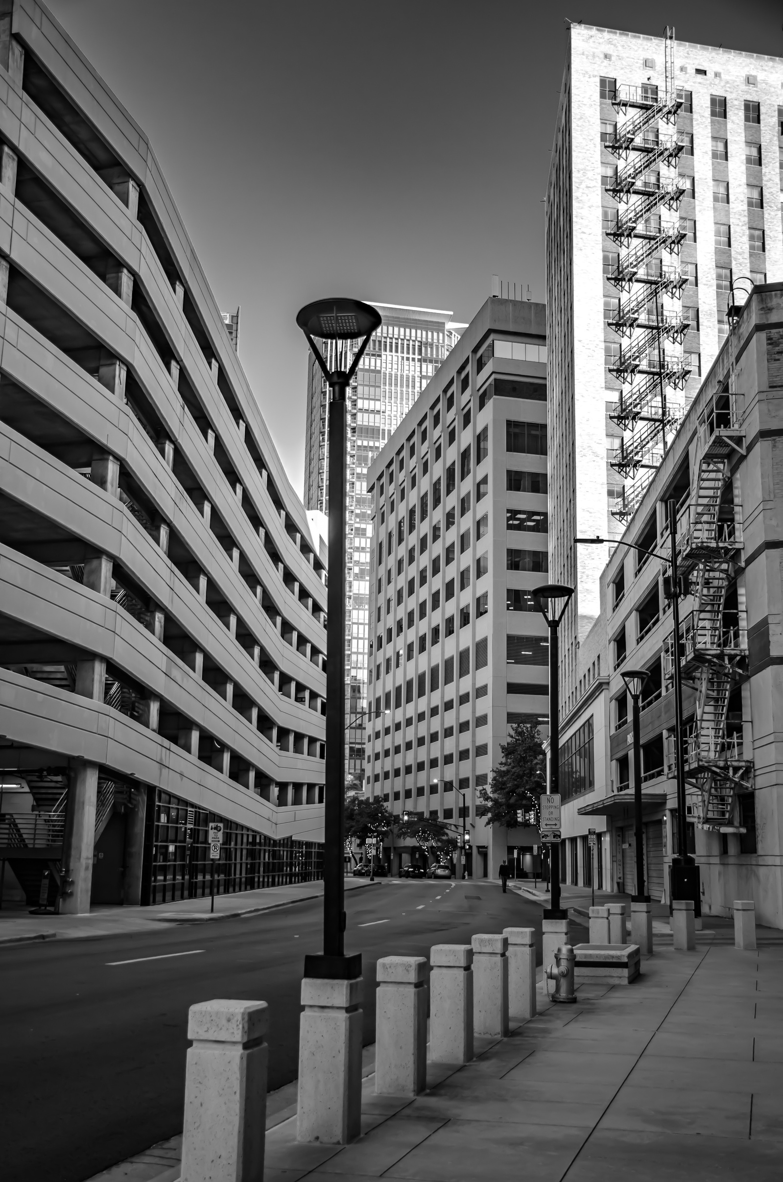 The city softens unexpectedly. Concrete curves, shadows bend, and the rigid grid flexes. Symmetry starts to breathe, creating rhythm in a place known for its order.