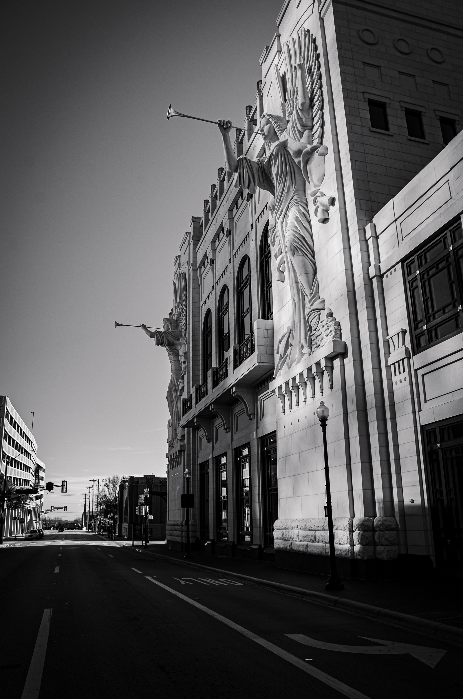 Time holds its breath between stone and street. This is architecture as proclamation—cast in shadow, etched against the pale quiet of morning.