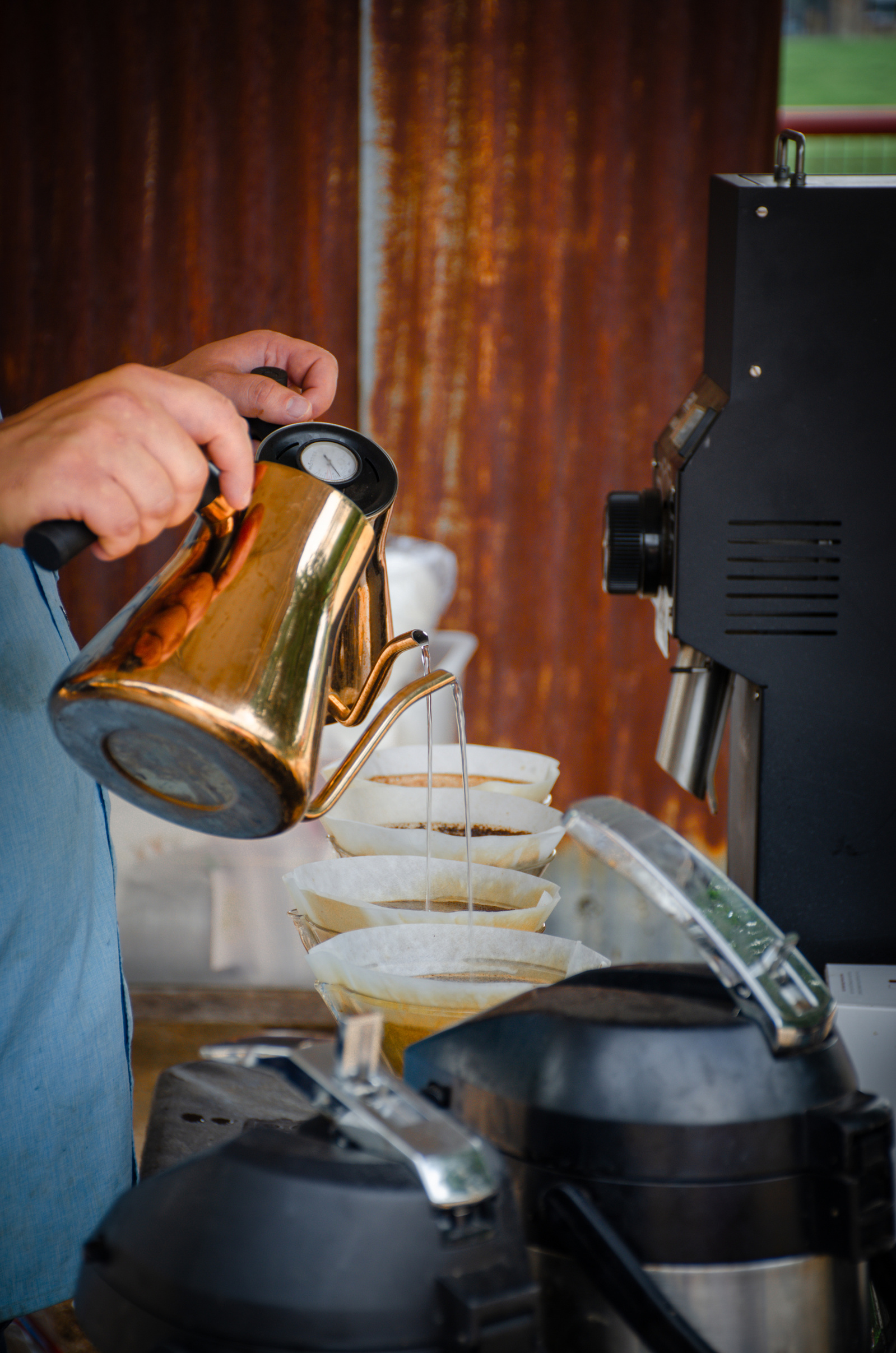 A quiet moment amidst the chaos—precision in the pour, copper glint in the light. While the streets hum with tricks, here it’s all about craft and ritual.