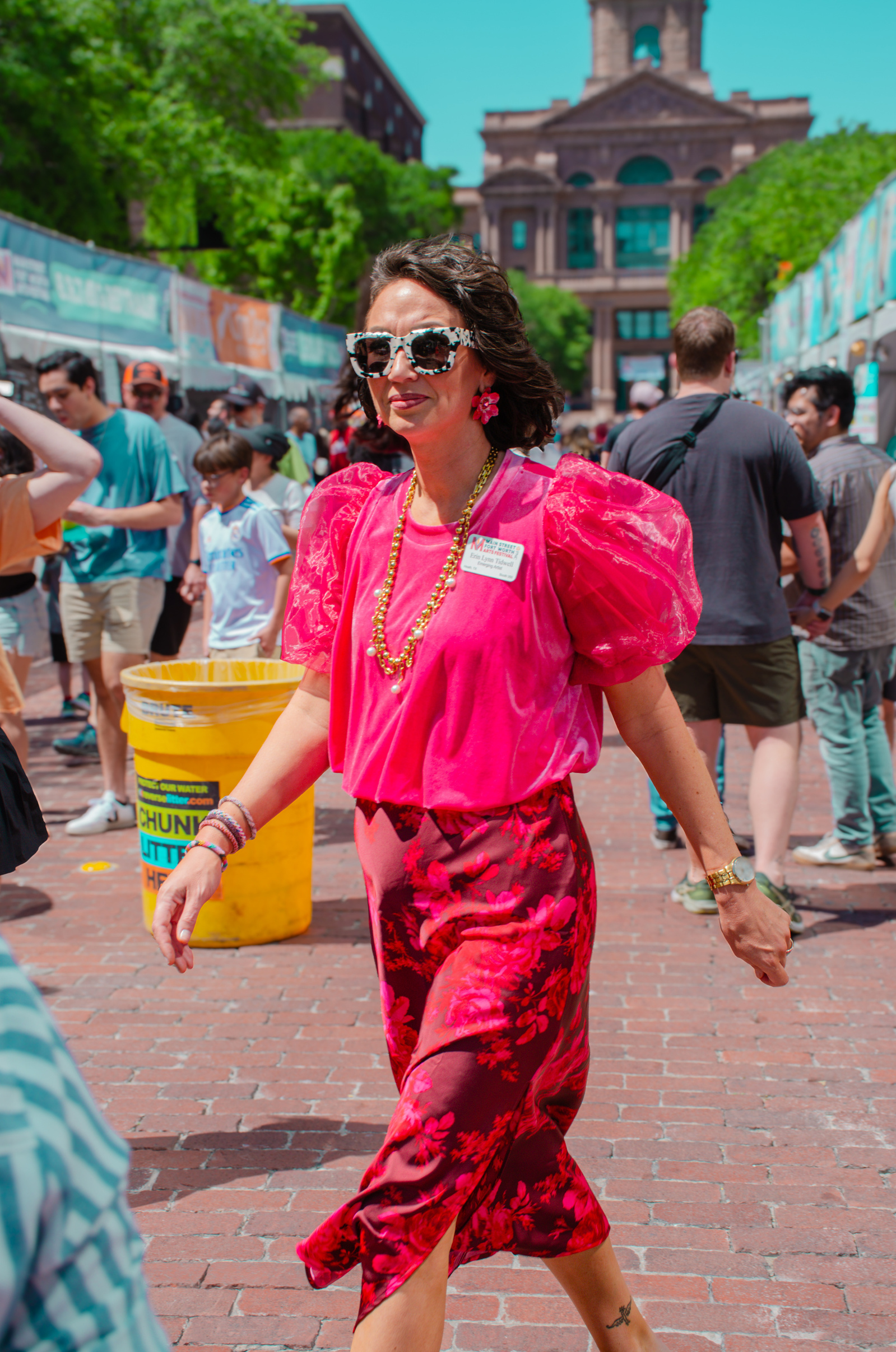 She’s not part of the crowd—she’s the punctuation mark in the middle of the sentence. Fierce, floral, forward.