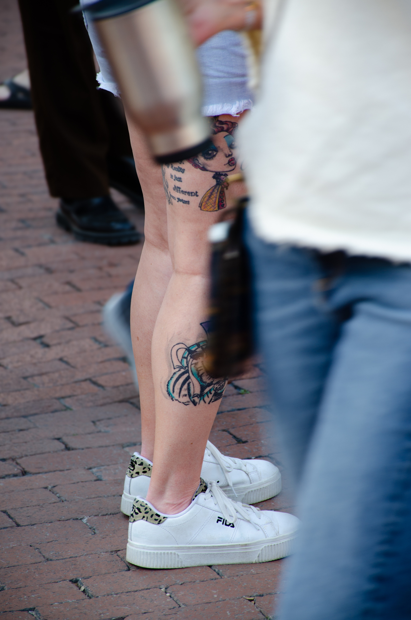 Legs in motion, skin in story—this one’s walking through life like it’s already been inked.