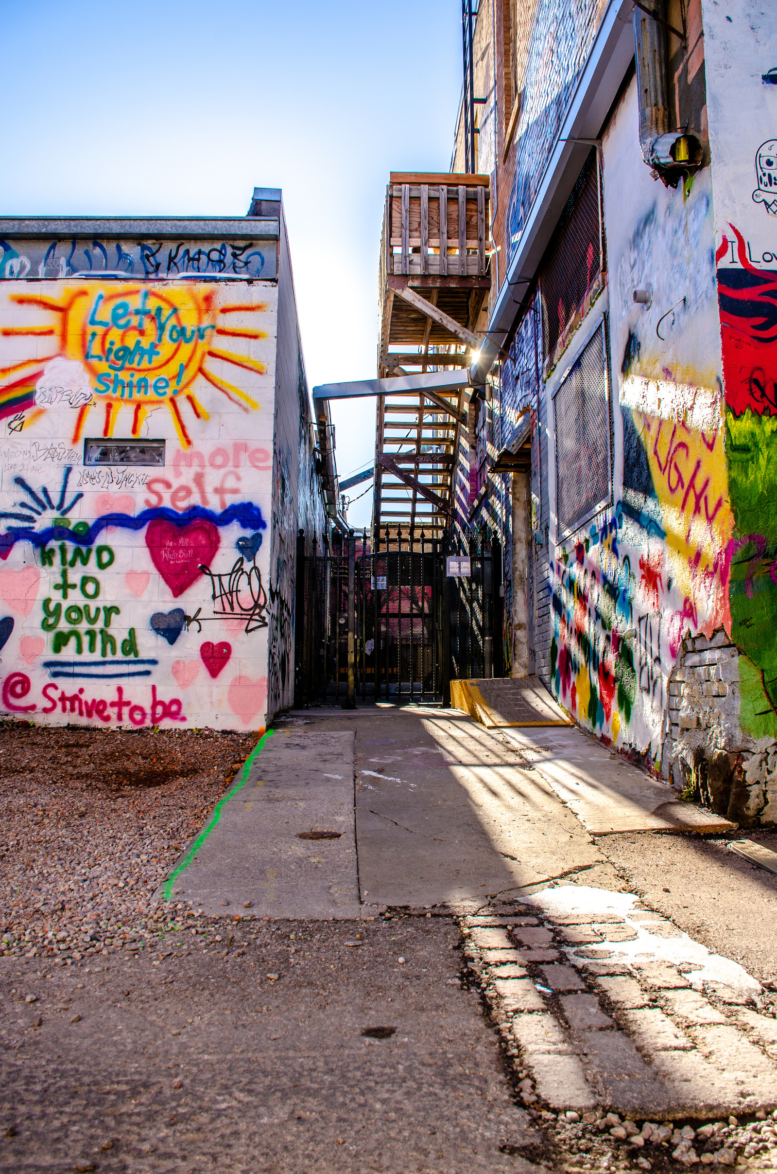 Inspirational street art brings color and light to industrial spaces. The message of hope emerges from vibrant hues and dynamic forms, demonstrating how urban art can transform forgotten corners into beacons of positive expression.