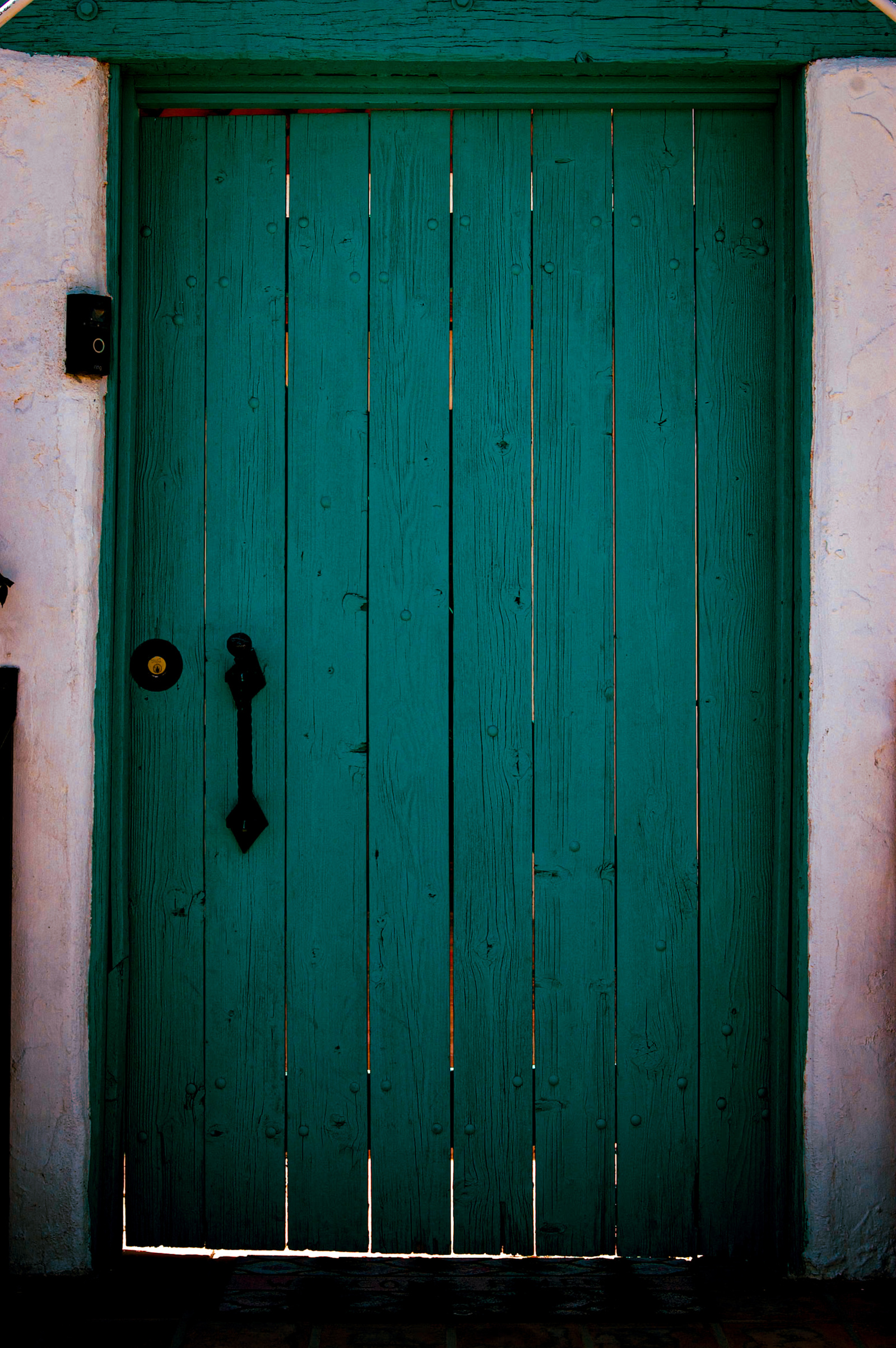 Closed but not locked — holding shadows and possibilities. There’s something just past the threshold, but the silence says it’s not quite time yet.