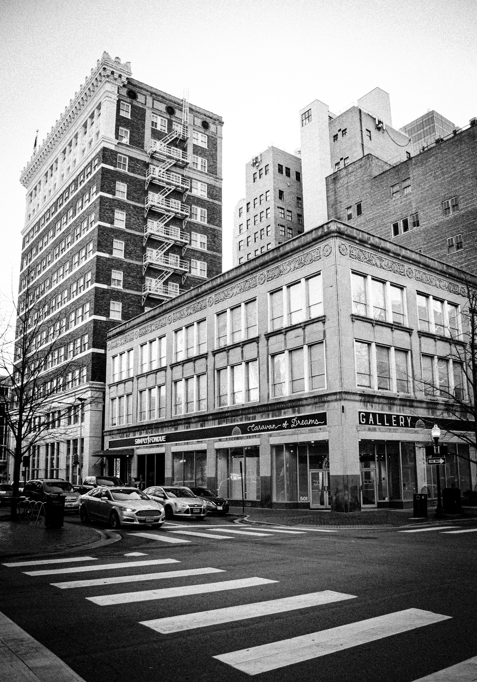 The city wears nostalgia like a second skin. Ghost signs, gallery walls, and quiet corners blur into a shape you almost recognize—familiar but untouchable, like a dream half-woken from.
