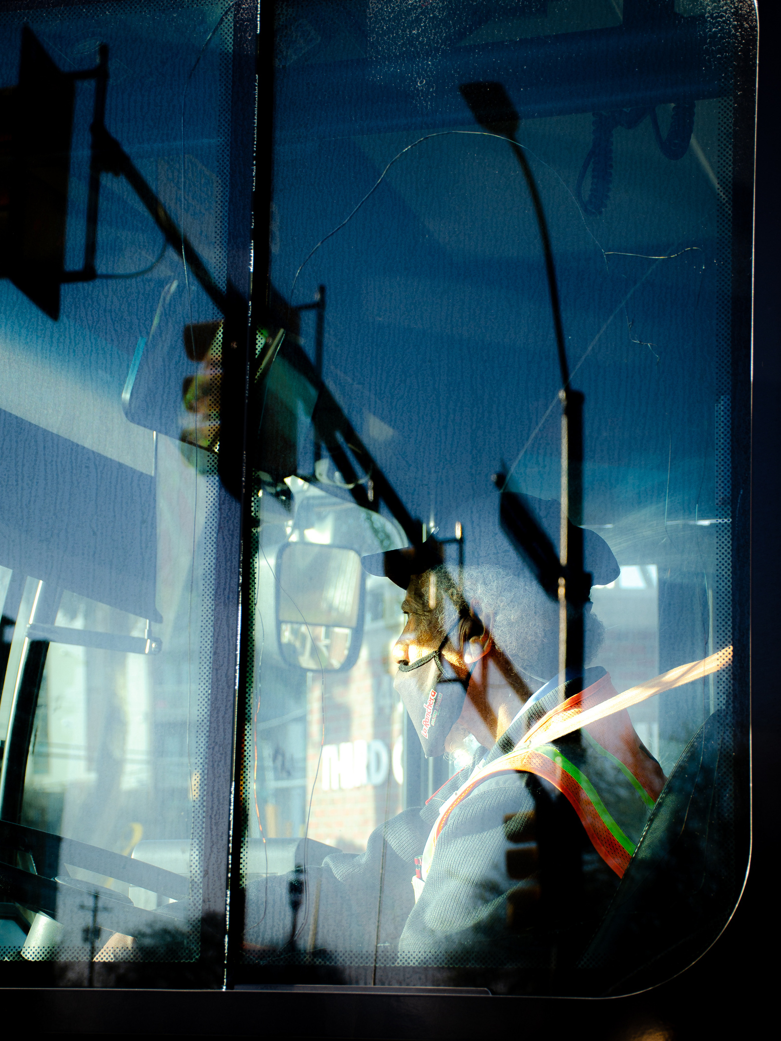 One part driver, one part streetlight. Caught in the city’s glassy overlap, he becomes both passenger and pilot of the morning.