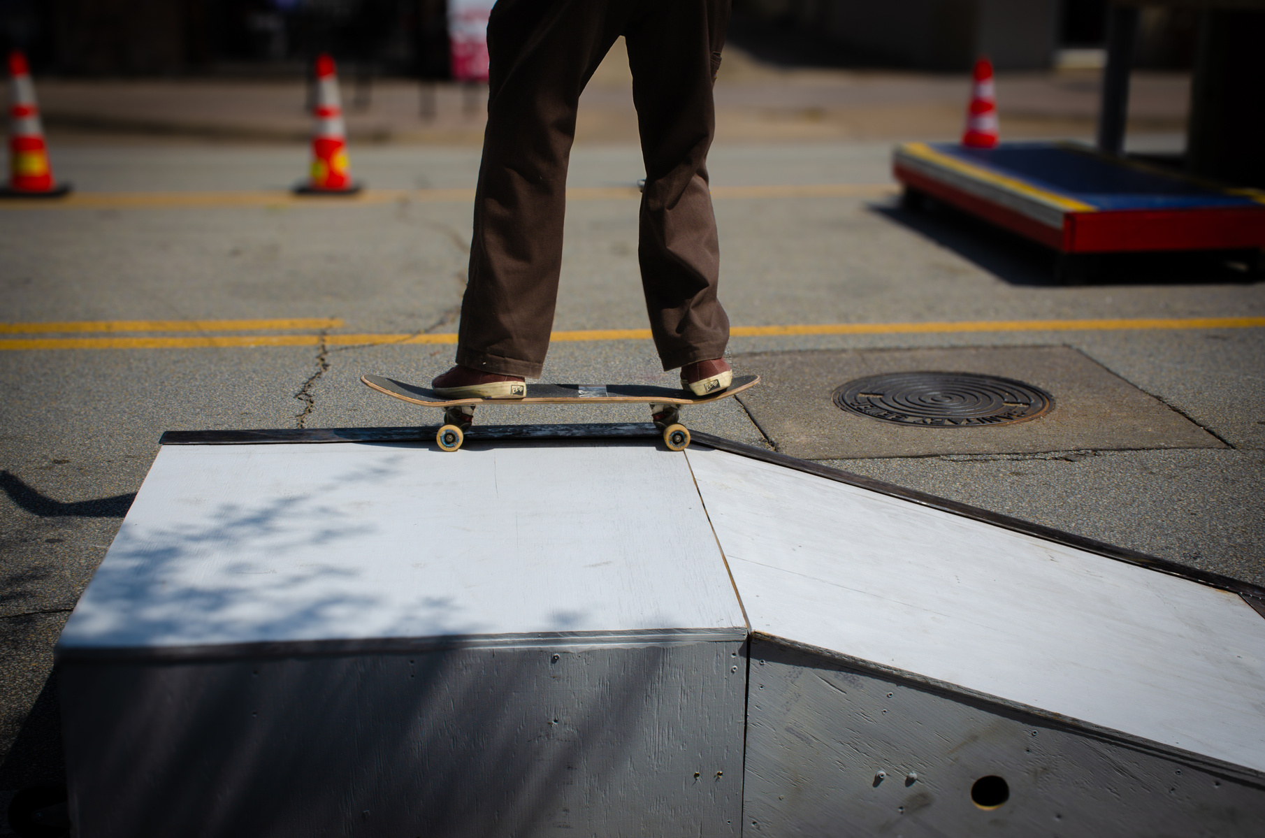 A quiet moment mid-movement—balanced at the edge of momentum. This frame catches the threshold between control and collapse, as if the ramp is waiting to tip the story forward. Urban geometry and soft shadows create tension, but the stillness is temporary