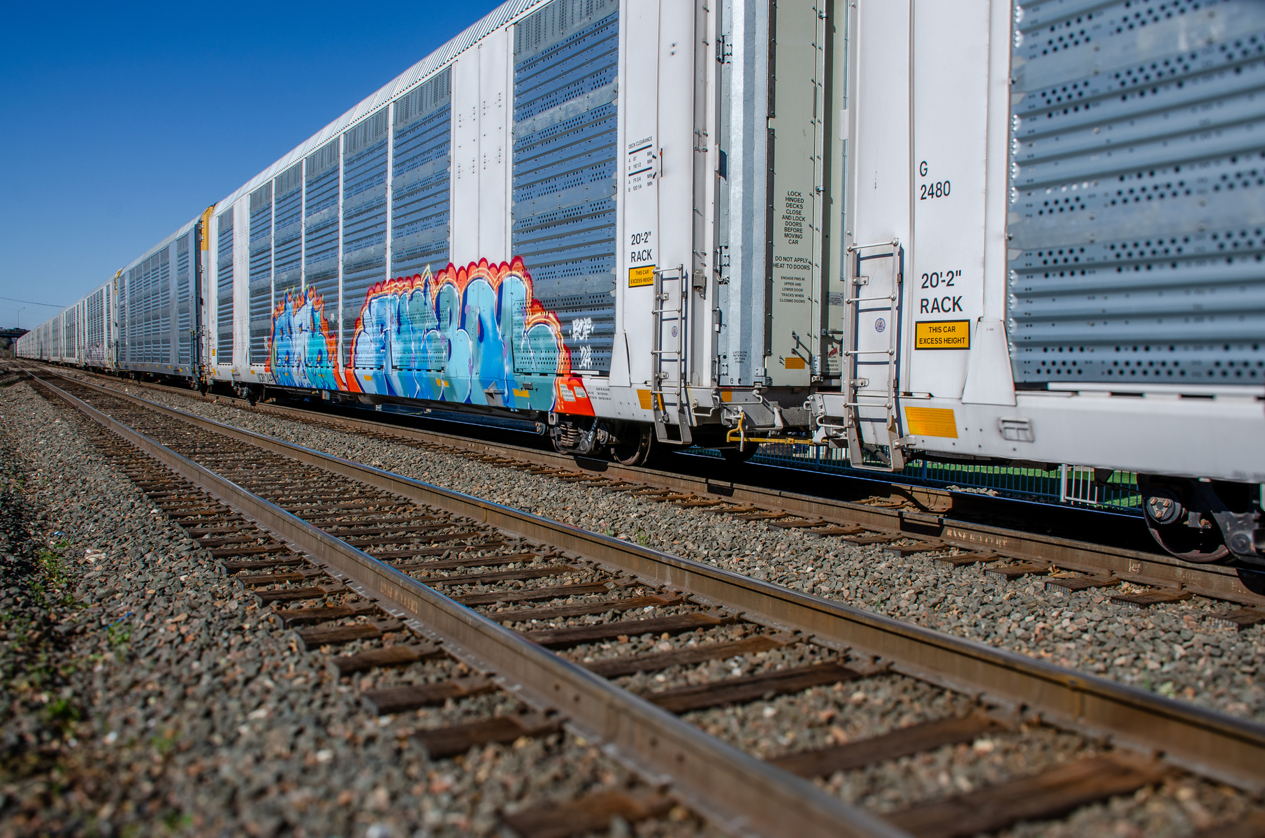 The same train, a new angle—this time the graffiti becomes art in motion. Texture, color, and code spray over steel, reminding us that movement carries more than goods—it carries stories.
