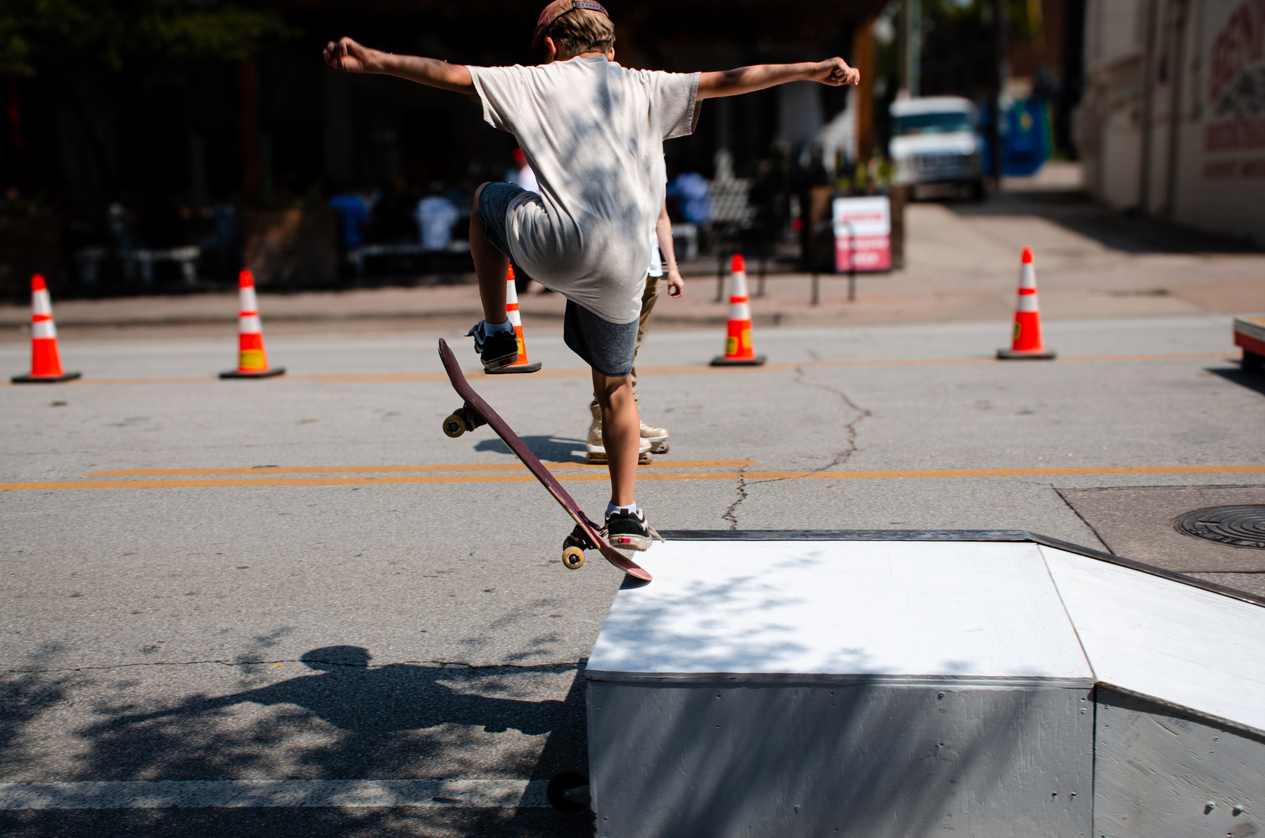 Frozen mid-air, the board lifts in a clean arc while the skater rides the line between street and sky. It's a study in angles and ambition, where focus overrides fear.