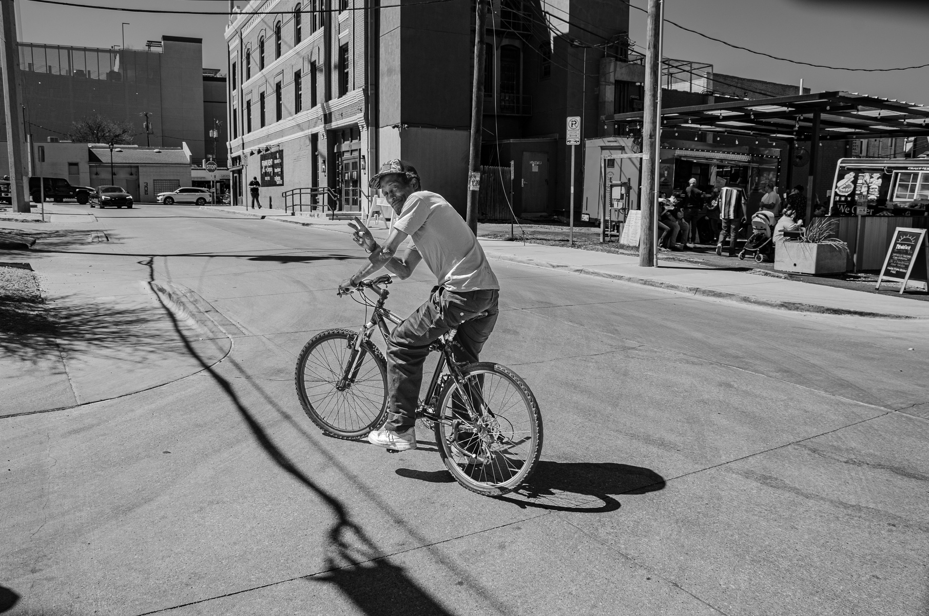 A gesture, a grin, a quiet kind of swagger. On two wheels, against the grain, he owns the lane. This image doesn’t ask for permission—it just says, “I’m here.”