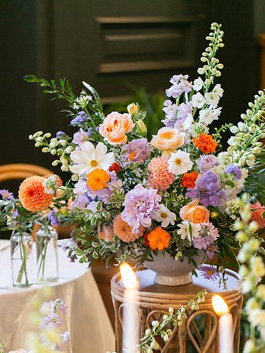 A vibrant bouquet of roses, cosmos, and seasonal blooms captured by an inclusive Sacramento wedding photographer focusing on colorful floral details.